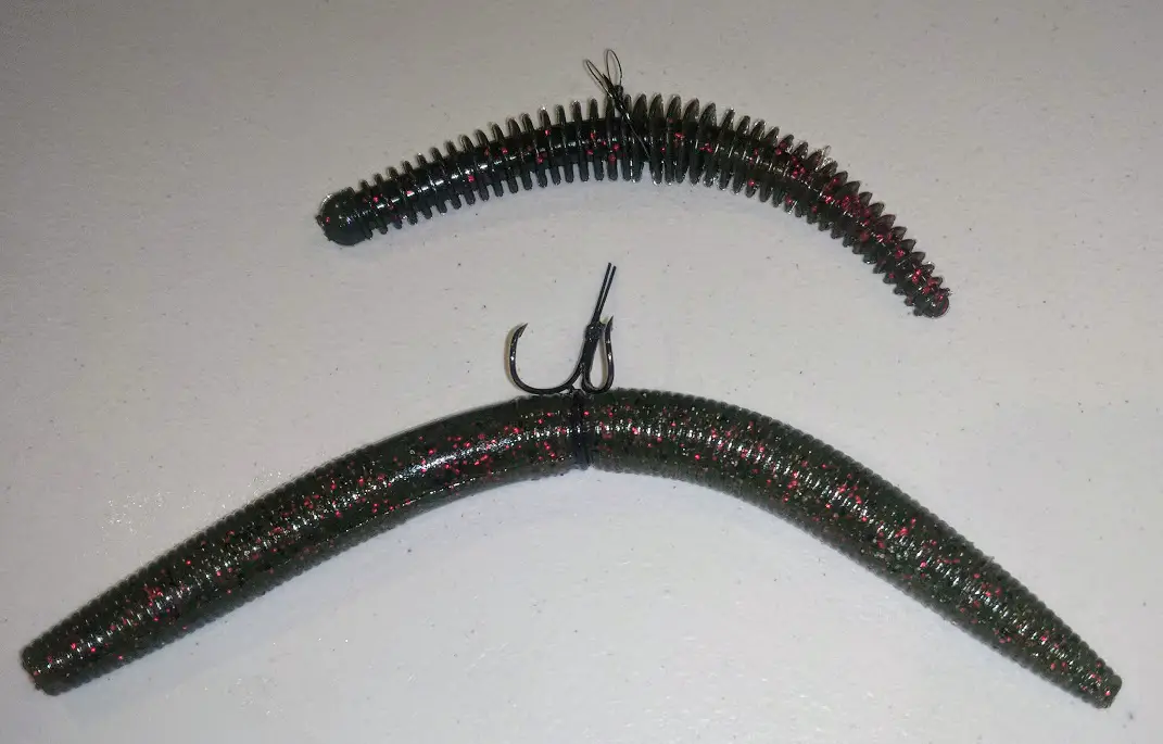 Two wacky worm rigs; one with a weedless hook and a worm with ribs around it and the other is a senko type worm rigged up through a black rubber o-ring on a different type of weedless hook